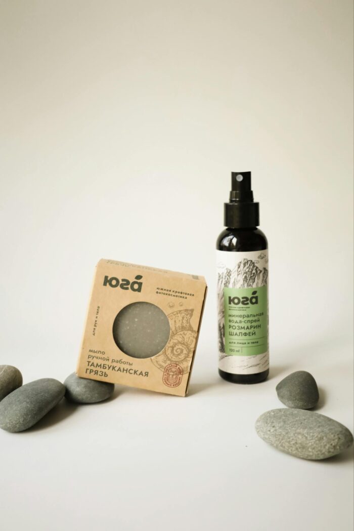 Elegant display of natural skincare products surrounded by smooth stones.