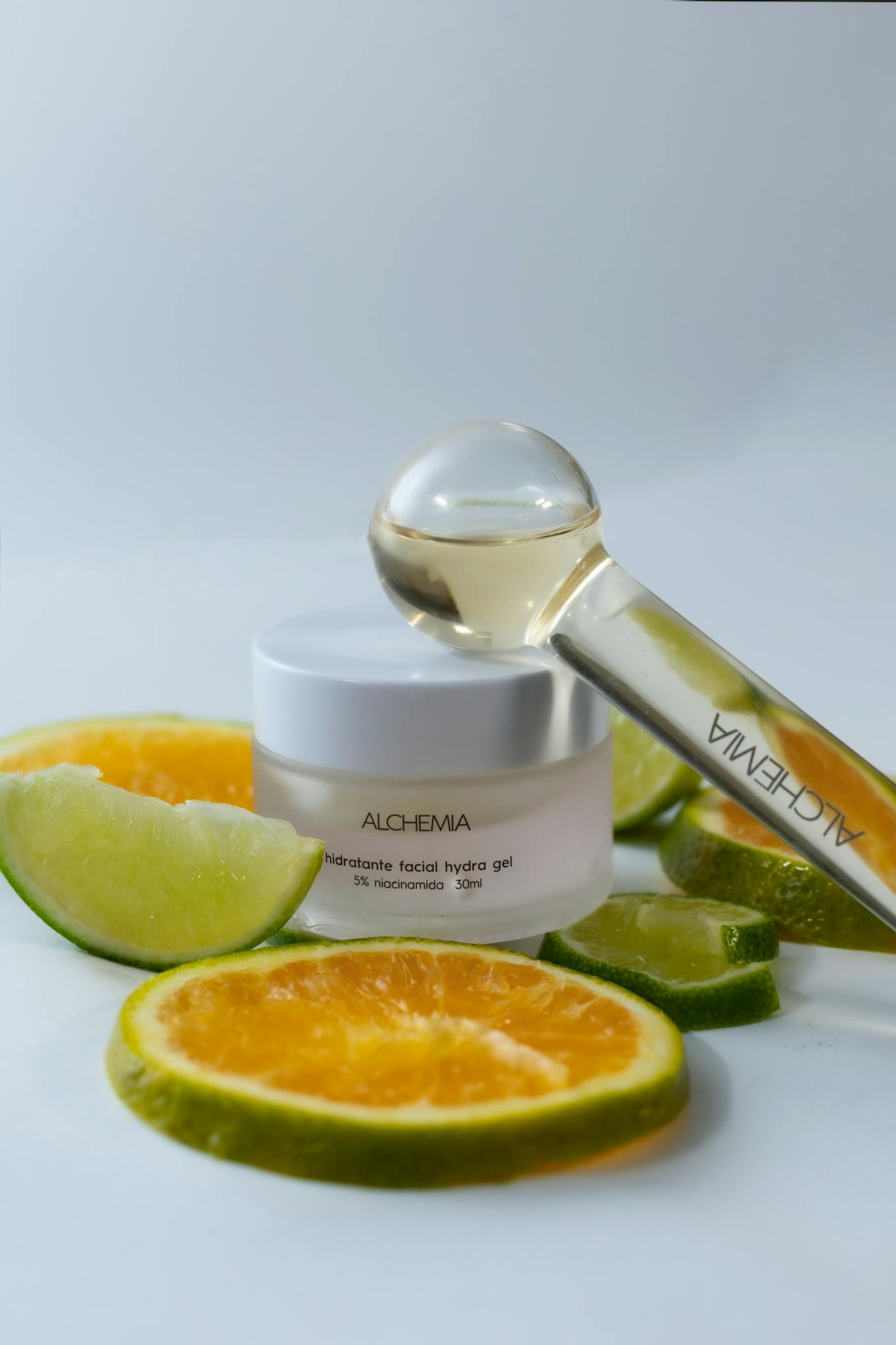 Hydrating gel with citrus slices and serum dropper on a white background.