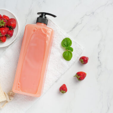 Cosmetic bottle strawberry shampoo on white backgroud