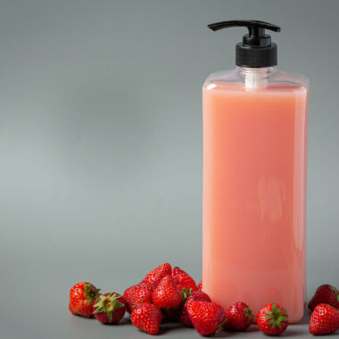 Cosmetic bottle strawberry shampoo on white backgroud